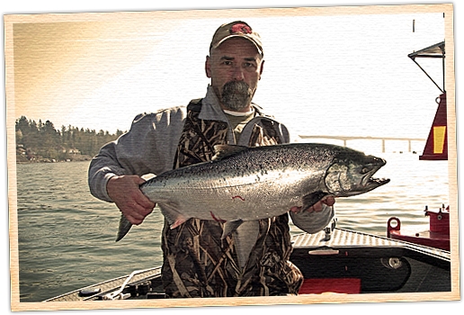 A man holding a large fish on top of a boat.