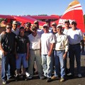 A group of people standing in front of an airplane.