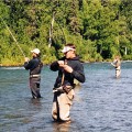 A group of people fishing in the water.