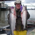 A man holding two fish in his hands.