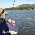 A person in the water holding onto a fishing rod.