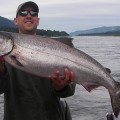 A man holding a large fish in front of him.