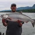 A man holding a large fish in front of him.