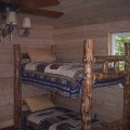 A room with two bunk beds and a ceiling fan.