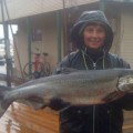 A man holding a large fish in front of him.