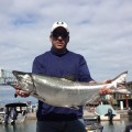 A man holding a large fish in his hands.