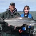 A man and woman holding up a fish.