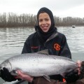 A man holding a large fish in front of him.