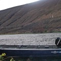 A boat is in the water near some mountains.