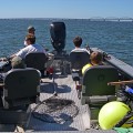 A group of people on a boat in the water.