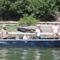 A group of people in a boat on the water.