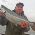 A man holding a large fish in his hands.